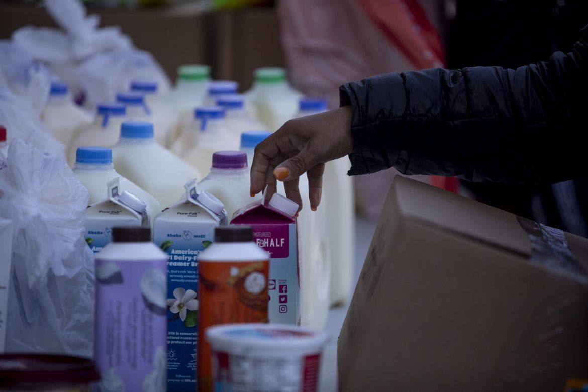 A federal worker moves through the food distribution line.